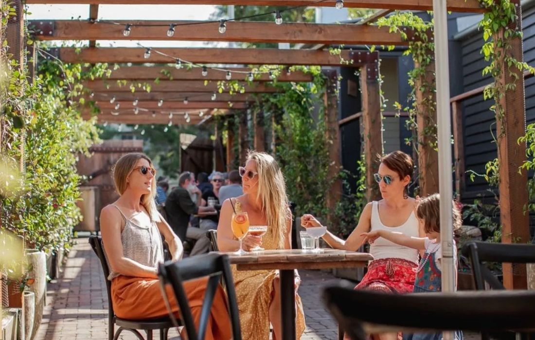 ladies sitting in the courtyard at Pomona Distilling Co